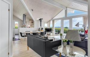 a living room with a couch and a table at Holiday Home Havremarken Sjølund Ii in Hejls