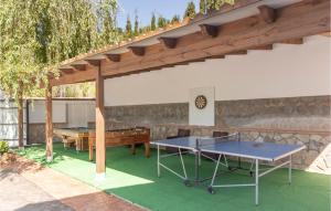 a patio with two ping pong tables and awning at 4 Bedroom Nice Home In Cómpeta in Acebuchal