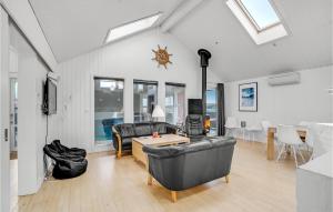 a living room with a couch and a table at Stunning Home In Thisted With Sauna in Klitmøller