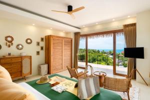 a living room with a view of the ocean at Wild Cottages Luxury and Natural - SHA Extra Plus Certified in Lamai