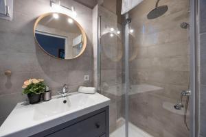 a bathroom with a sink and a shower with a mirror at Charming Central Dream Home & Retreat by Prestige Homes in Budapest