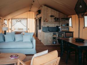 a living room with a couch and a table at the YellowBoxWood Heathcote - Echidna Ridge and Emu Valley Tents x 2 in Heathcote
