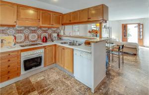 a kitchen with a sink and a stove top oven at Beautiful Apartment In Estepona in Estepona