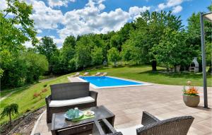 a backyard with a pool and chairs and a table at Three-Bedroom Holiday Home In Ludbreg in Ludbreg +40 photos