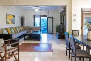 ein Wohnzimmer mit Sofa und Tisch in der Unterkunft Sani Pinecone Villa 3 in Sani Beach + 24 Fotos