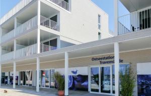 a large white building with a sign that reads orchestration therapy at Priwallpromenade 27, Whg 4 in Priwall