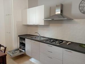 a kitchen with a sink and a stove top oven at Casa Vacanza Nenè in Partanna