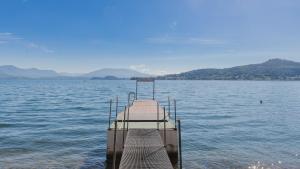 a dock in the middle of a large body of water at Hotel Bel Sit in Meina