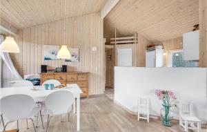 a kitchen and dining room with a white table and chairs at Holiday Home Sandleddet Højby Ii in Lumsås