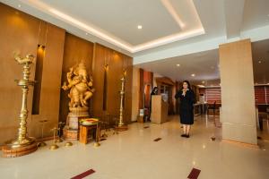 a woman walking down a hallway in a building at THE SEASHORE HOTEL in Kanyakumari