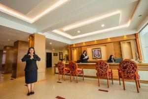 a woman is standing in front of a mirror at THE SEASHORE HOTEL in Kanyakumari