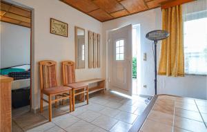 a room with a table and a chair and a door at One-Bedroom Holiday Home In Bellin in Bellin