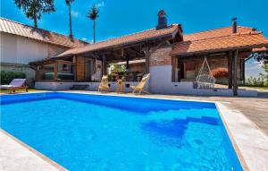 a swimming pool in front of a house at Gorgeous Home In Martinkovec With Sauna in Jarki Horvatićevi