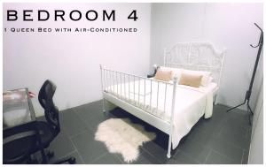 a bedroom with a bed with a white crib and a chair at Harris Homestay Gerik Town, Free Wifi & Netflix in Gerik