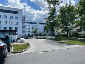 a parking lot in front of a building at Apartament Akacjowa in Gollnow