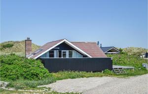 a house sitting on the side of a road at Holiday Home Hvide Sande 20 in Bjerregård