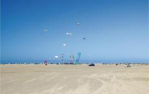 a group of people flying kites on the beach at Lovely Home In Rømø With Sauna in Bolilmark