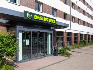 a building with a bbb hotels sign on it at B&B Hotel Hamburg-Airport in Hamburg