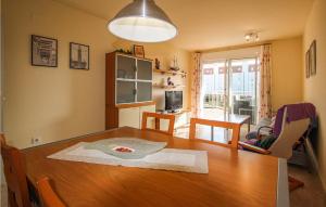 a kitchen and dining room with a wooden table at Nice Apartment In Mont-Roig Del Camp in Miami Platja