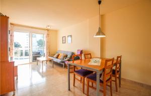 a living room with a table and chairs and a couch at Nice Apartment In Mont-Roig Del Camp in Miami Platja