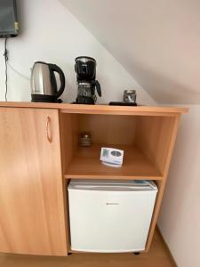 a wooden shelf with a microwave and a toaster at MAT & EDW RooM in Câmpulung Moldovenesc