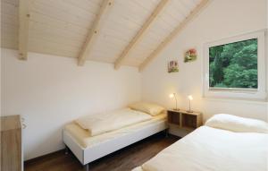 Ein Bett oder Betten in einem Zimmer der Unterkunft Ferienhausdorf Thale