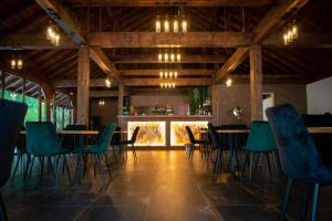 a dining room with tables and chairs and a bar at The Grand Prestige Igloo in Gura Teghii
