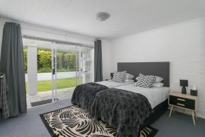 a bedroom with a large bed and a large window at Herons House in Knysna +42 photos