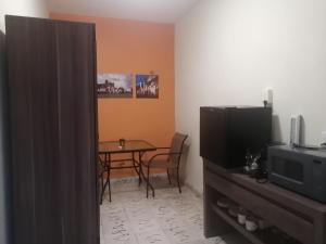 a living room with a table and a television at Naj Wayak´ Departamentos in Valladolid