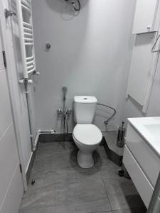 a bathroom with a white toilet and a sink at Feel at home chugureti in Tbilisi City