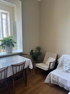a dining room with a table and a chair at Feel at home chugureti in Tbilisi City +16 photos