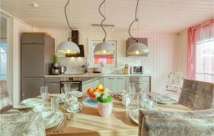 a kitchen with a table with a bowl of fruit on it at Gorgeous Home In Zerpenschleuse in Zerpenschleuse