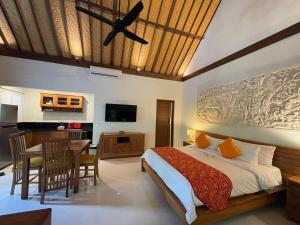 a bedroom with a bed and a dining room at Bali Santi Bungalows in Candidasa +63 photos
