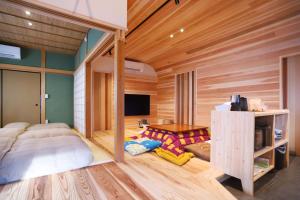 a bedroom with a bed and a tv in it at ぽつぽつあん in Ise