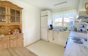 a kitchen with a white refrigerator and a sink at 3 Bedroom Awesome Home In Falkenberg in Falkenberg