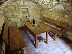 a wooden table and benches in a stone room at U kapličky, Boskovice in Boskovice