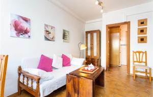 a living room with a white couch and a table at Cala Morlanda Palma D Mallorca in S'Illot