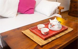 a tray with two cups and a tea pot on a table at Cala Morlanda Palma D Mallorca in S'Illot