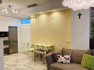 a living room with a couch and a table at Comfy Camel Apartment in Budapest