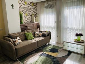 a living room with a couch and a glass table at Comfy Camel Apartment in Budapest