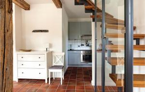 a small kitchen with a staircase in a house at Cozy Home In Gammelby With Sauna in Gammelby +7 photos