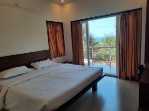 Postel nebo postele na pokoji v ubytování Raapan Beach Resort