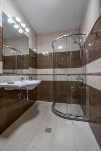a bathroom with a sink and a shower at Plaza Hotel Plovdiv - Free Parking in Plovdiv