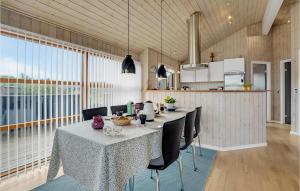 a dining room with a table and chairs and a kitchen at Holiday Home Sydals With A Fireplace 08 in Neder Lysabild