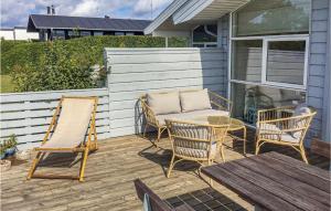 a patio with chairs and a table and a bench at Søhus in Fæbæk