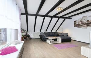 a living room with a black couch and a table at Stunning Apartment In Marienmünster in Schieder-Schwalenberg