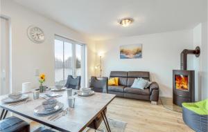 a living room with a table and a fireplace at Nice Home In Tossens With Kitchen in Tossenserdeich +19 photos