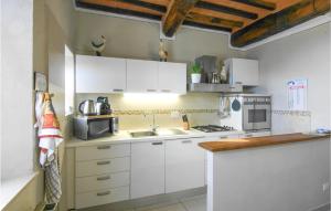 a kitchen with white cabinets and a sink at Awesome Home In Macchino With Kitchen in Marliana