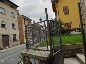 an iron gate on a street in a city at La casa di Eleonora in Campodolcino +2 photos