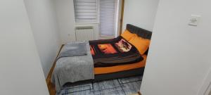 a bed in a small room with at Stan Vogosca in Vogošća